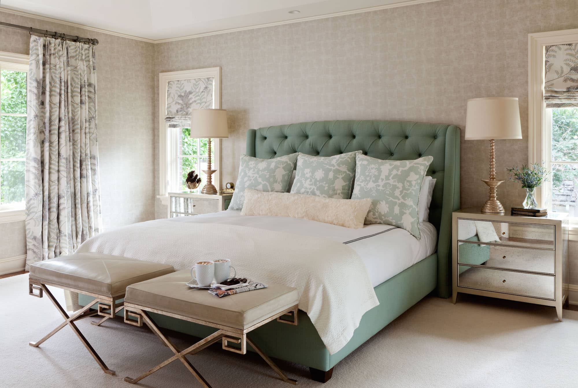 Tamba wallpaper by Osborne & Little wraps the bedroom walls in tranquility. Further subtleties come from custom draperies in Rochelle by Colefax and Fowler and custom pillows donning a modernized chinoiserie Shantung Silhouette print by Schumacher. Photo by Emily Minton Redfield