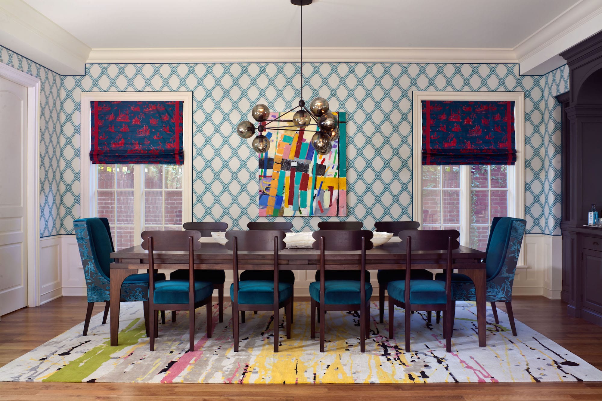 Designer Andrea Schumacher covered A. Rudin head chairs in Schumacher velvet and a Sansui three-dimensional cut velvet by Donghia. Brunschwig & Fils’ Bamboo Trellis pattern climbs the walls of the dining room. Photo by Emily Minton Redfield