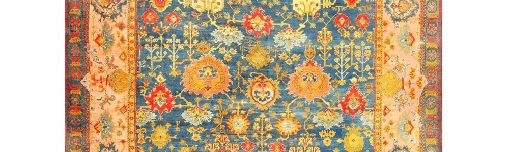 A Turkish Oushak rug featuring rich blues and earth tones