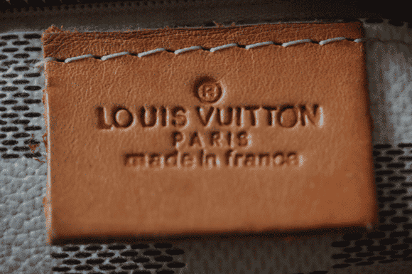 Fake Louis Vuitton Bags How To Spot A Real One Top An Authentic Louis Vuitton Stamp Bottom Indications Of Fakery On This Counterfeit Include The Unfinished Edges And Slightly Oval Letter O