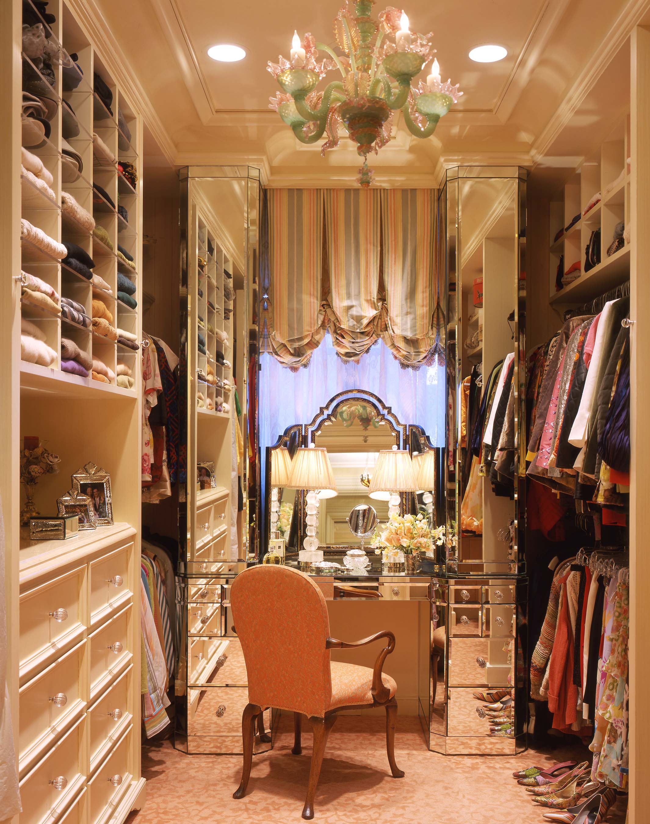 A vintage Venetian chandelier hangs above a custom mirrored dressing table and rock-crystal lamps in this jewel-box dressing area belonging to a San Francisco Beaux Arts residence by Suzanne Tucker.