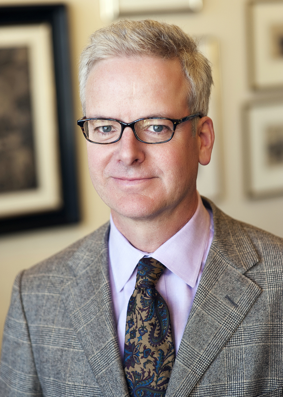 Peter Pennoyer established his architectural firm, which focuses largely on residential projects, in 1990 (photo by Jay Ackerman). Top: In the library of a brownstone in New York's Carnegie Hill that his firm renovated, Pennoyer moved the staircase and added a sequence of arches to articulate the space. Photo by Scott Frances