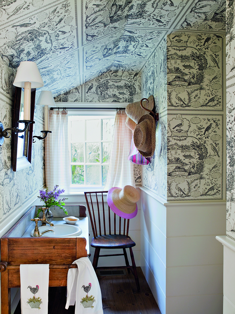 Scheerer used an American bird toile from Schumacher to help camouflage the odd angles of a pantry turned powder room in East Hampton, New York.
