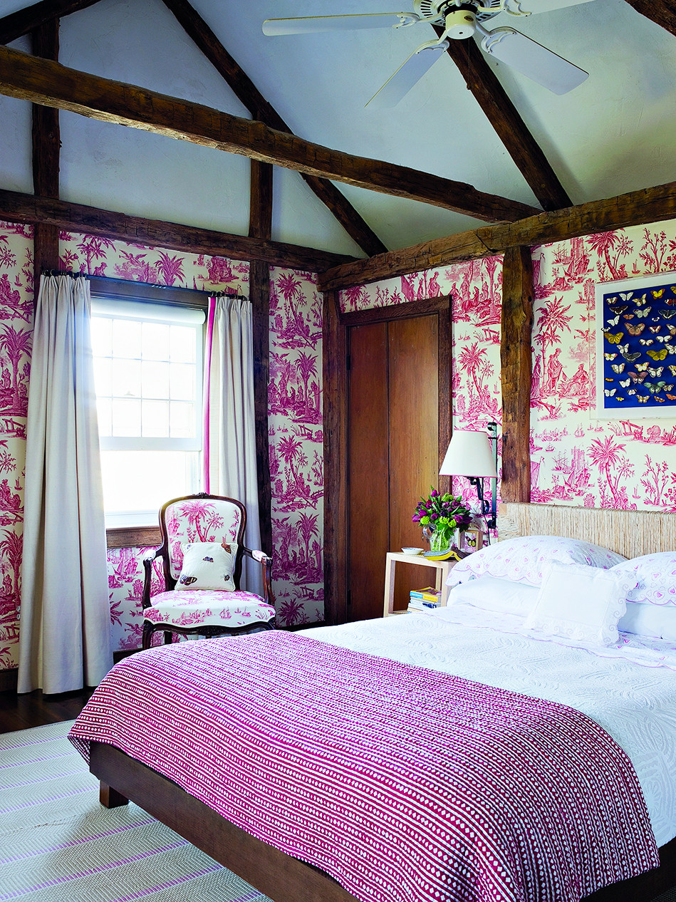 In an 18th-century farmhouse in East Hampton, New York, Scheerer created a bedroom at once modern and traditional, covering the walls and chair in Lafayette, a toile de Jouy from Quadrille Fabrics, and installing above the rope headboard a butterfly shadow box he made by hand.