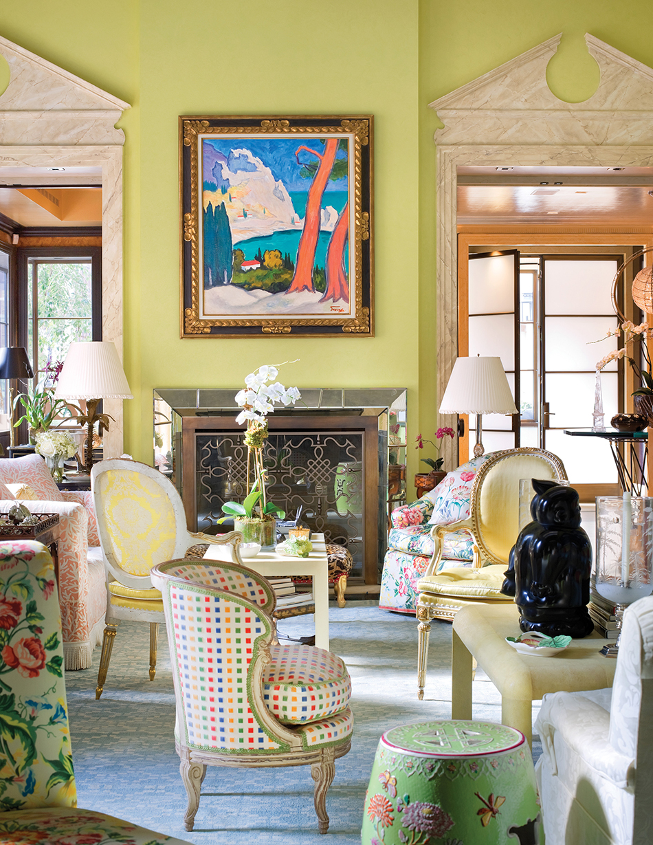 Mario Buatta increased the grandeur of the already-impressive living room of Hilary and Wilbur Ross’s Manhattan pied-à-terre by adding overdoor pediments and dentil molding. Photo by Scott Frances/Architectural Digest © Condé Nast Publications. Above: The designer stands in front of a whimsical painting that recalls one of his rooms. Photo by Jason Schmidt/Nest