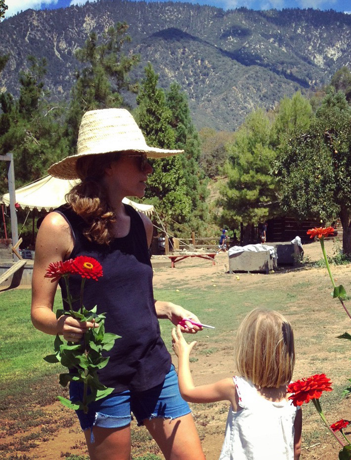 The designer has two young children of her own, including Honor, now five, seen here picking Gerber daisies with her mother at a California apple orchard. Photo by Chris Merrill