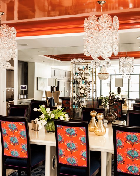 The designer carried the orange-and-blue motif of the Tribeca living room into the dining area, covering the seats of the chairs in navy mohair and their backs in orange fabric that complements the lacquered ceiling. The table was painted to resemble tessellated bone.