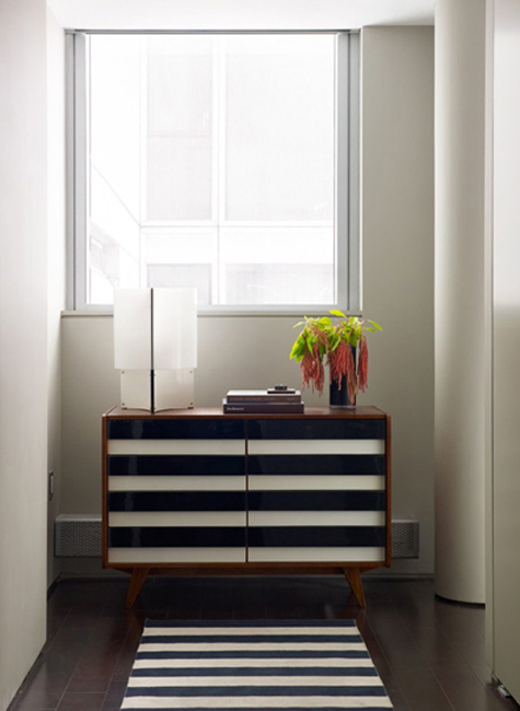 In a West Village apartment, A+L created an oversize headboard out of vintage leather wrestling mats they found at a flea market in Paris. The custom side table is by Studio Bronze and the bedding by Matteo. Photo by Lucas Allen