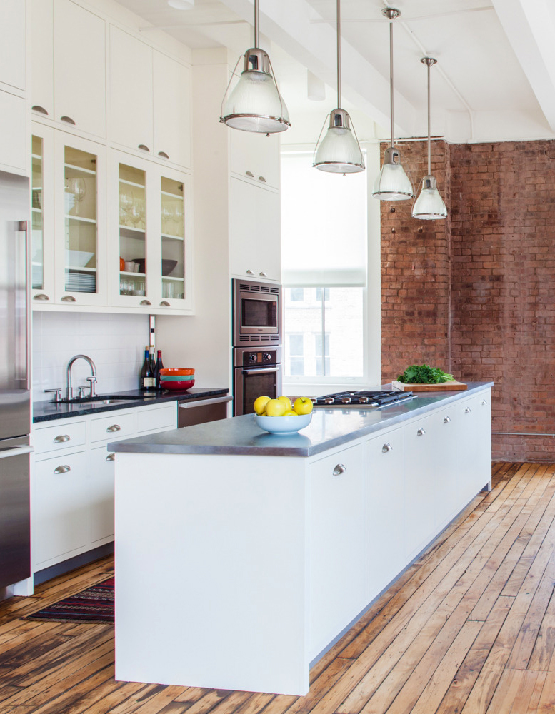 The revamped kitchen features floor-to-ceiling cabinets, soapstone counters and a zinc-top island. Photo by Brett Beyer, courtesy of Rumba