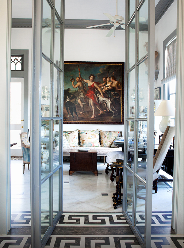 In the Peacock House, a pair of French doors that Gatewood found at the Pier Antiques Show, in New York, open to a living room dominated by a painting of Diana, goddess of the hunt.