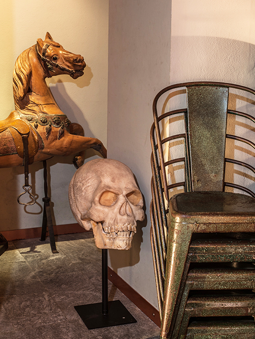 What would be unlikely juxtapositions elsewhere — an oversized Polyurethane sculpture of a skull, say, with a French 1890 carousel horse — are par for the course at Il Segno.