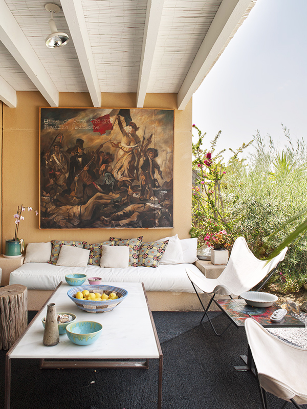 A contemporary take by the painter Arnaud on a classic Eugene Delacroix painting of the French Revolution hangs in the indoor-outdoor living room of a house in the Spanish town of Almería.