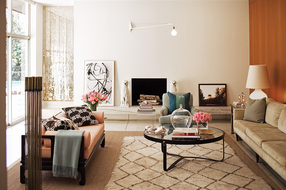 In the living room of the Pooles’ Charlotte home, a Jean Prouvé Metal Jib lamp keeps company with a Jacques Adnet coffee table from Galerie XX. Photo by Chris Edwards