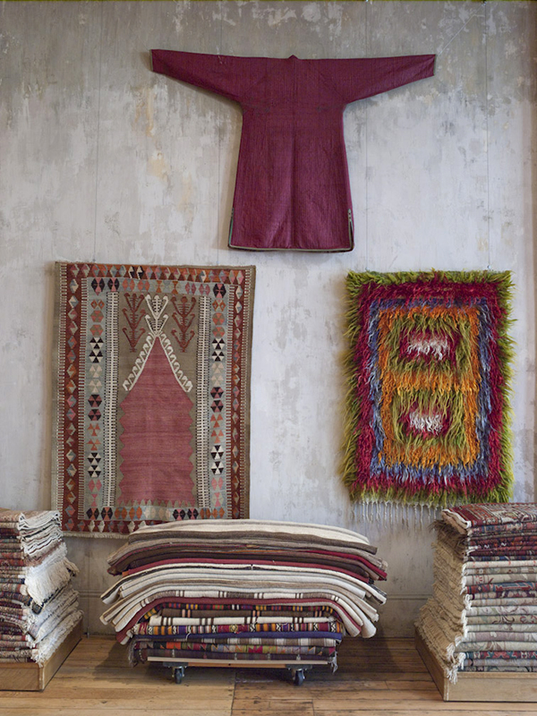 A 19th-century silk robe from Central Asia; a long-haired “tulu” rug in vibrant colors, mid 20th century, Western Turkey; a kilim with a prayer niche design, early 20th century, Central Turkey. Photo by John Gruen
