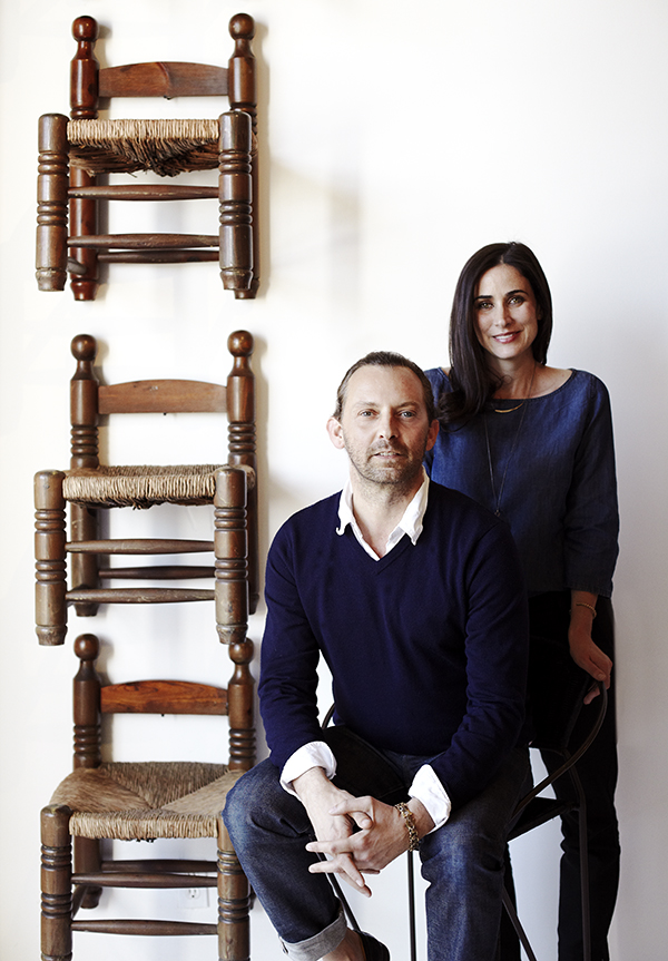 Nickey and Kehoe pose beside wood-and-rush fireplace stools, which are available on their 1stdibs storefront. Photo by Giovanni Jance