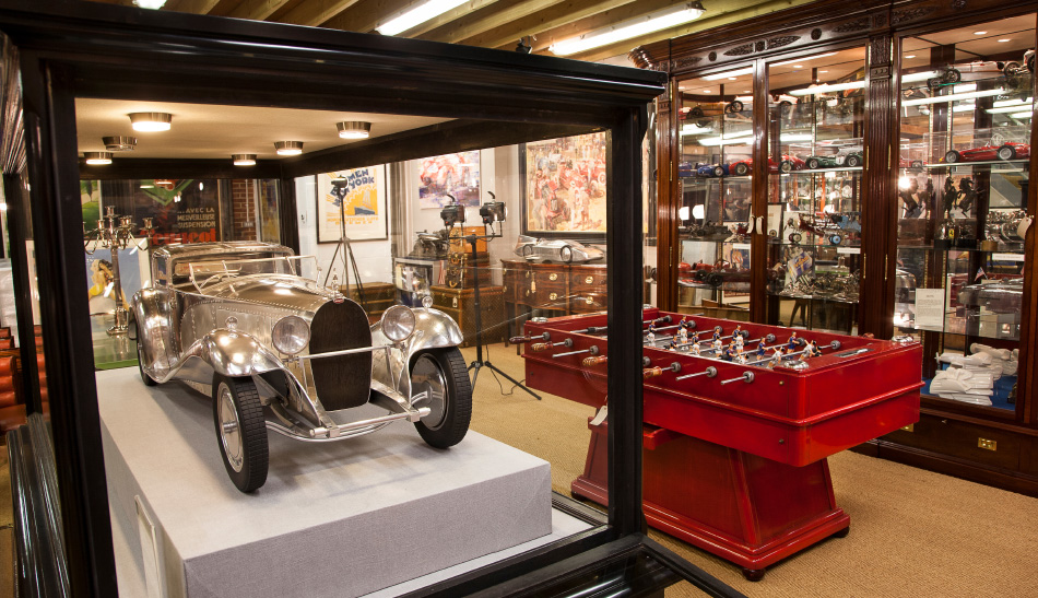At Pullman Studios, a unique model of the Bugatti Type 41 Royale Coupé Napoléon, by John Elwell, shares real estate with a vintage foosball table.