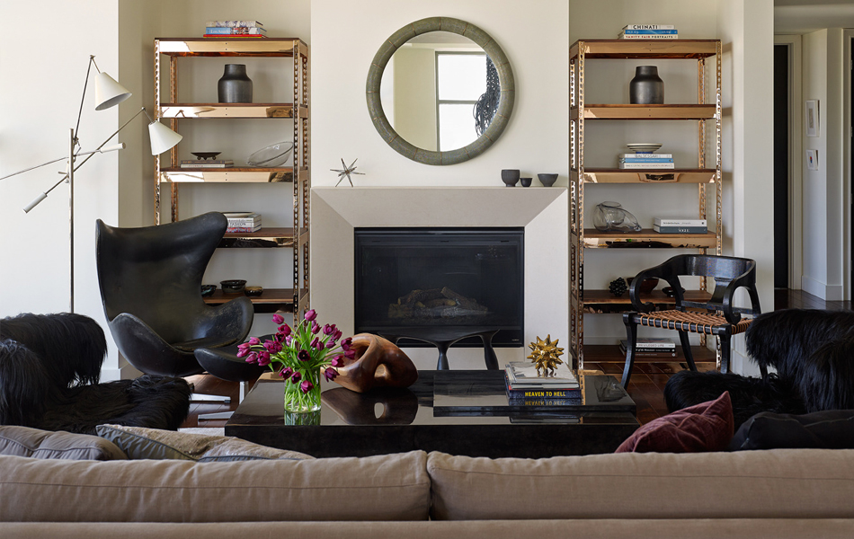 “This masculine penthouse apartment is a play on the tactile, layering various finishes and textures,” says Furth. Rose-gold and walnut bookcases from Furth’s forthcoming furniture line anchor the space. Photo by Jonn Coolidge