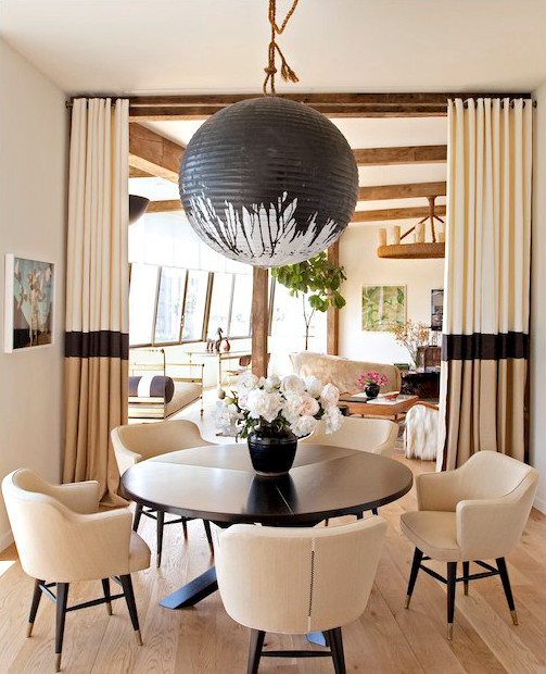 In the dining room of celebrity hairdresser Chris McMillan, the interior designer Trip Haenisch hung a custom black-splattered Noguchi lamp over a table surrounded by Edward Wormley chairs. Photo by Tim Street-Porter