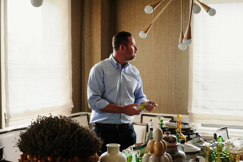 Gideon Mendelson surrounded by items found on travels with his mother