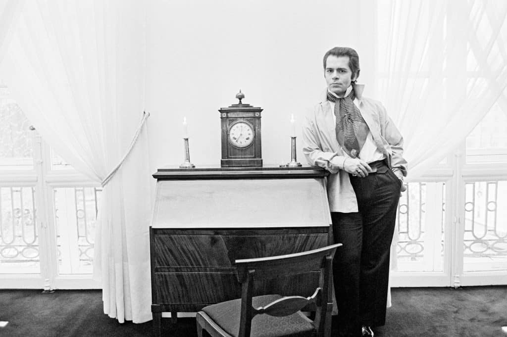 Karl Lagerfeld stands in his Paris home
