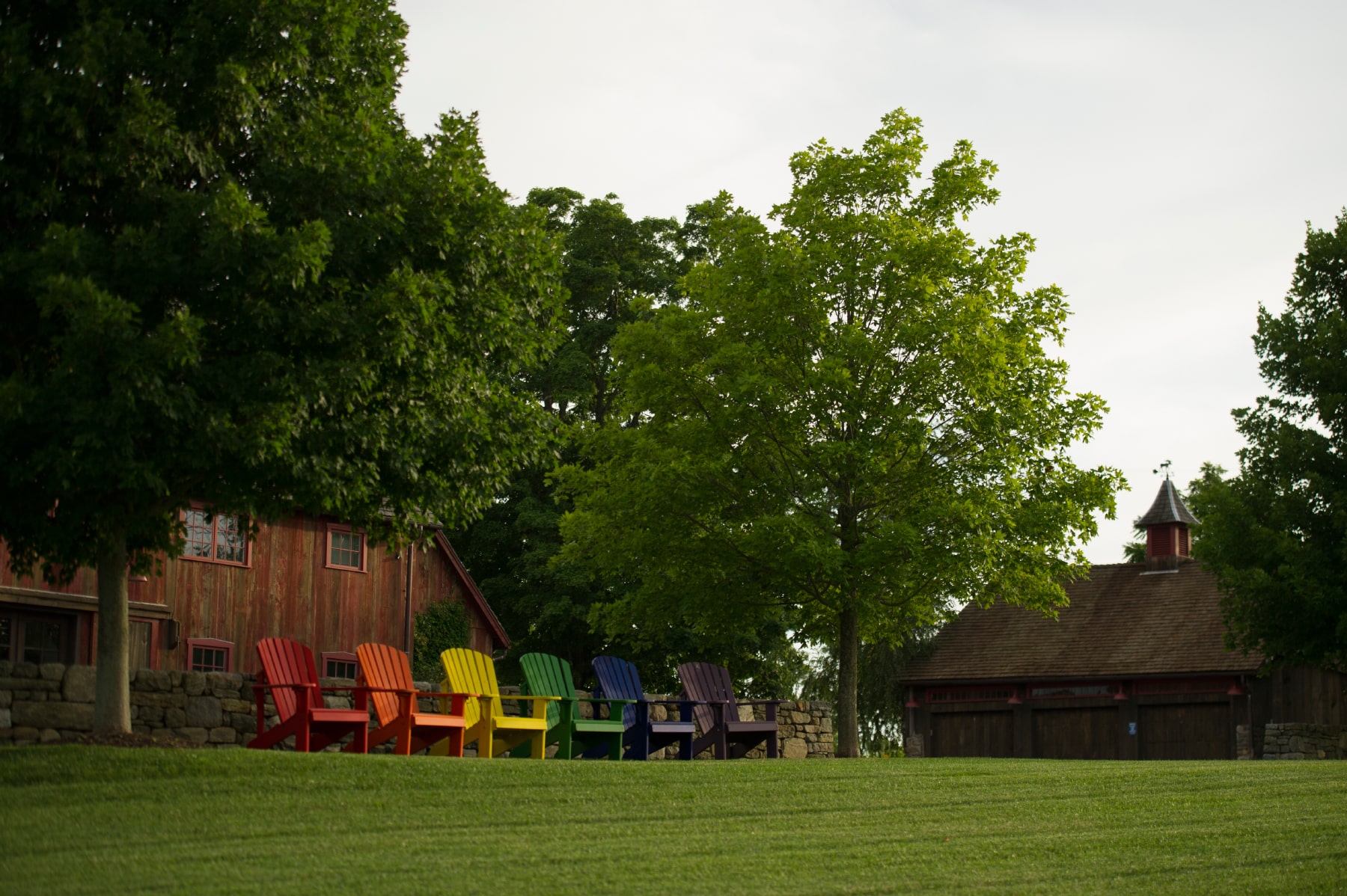 yard with rainbow adirondack chairs