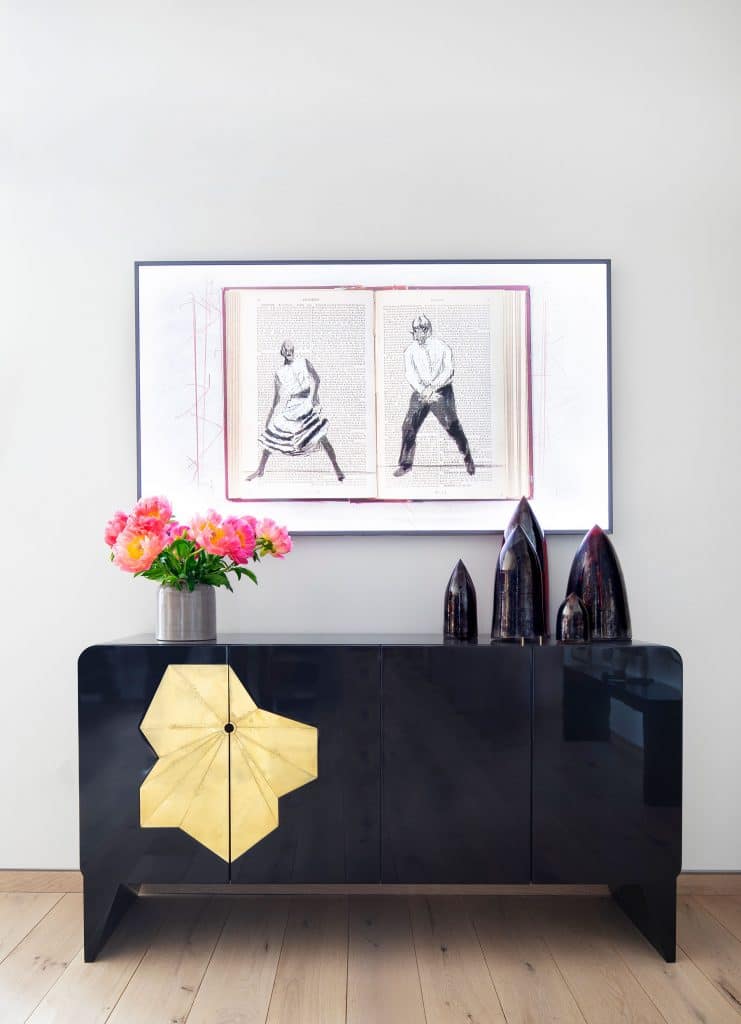 William Kentridge artwork is mounted above a Gloria Cortina cabinet and ceramics from Cristina Grajales Gallery