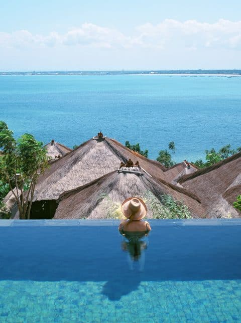 Annie Kelly in a pool at the Four Seasons Resort Bali at Jimbaran Bay, photographed by Tim Street-Porter.