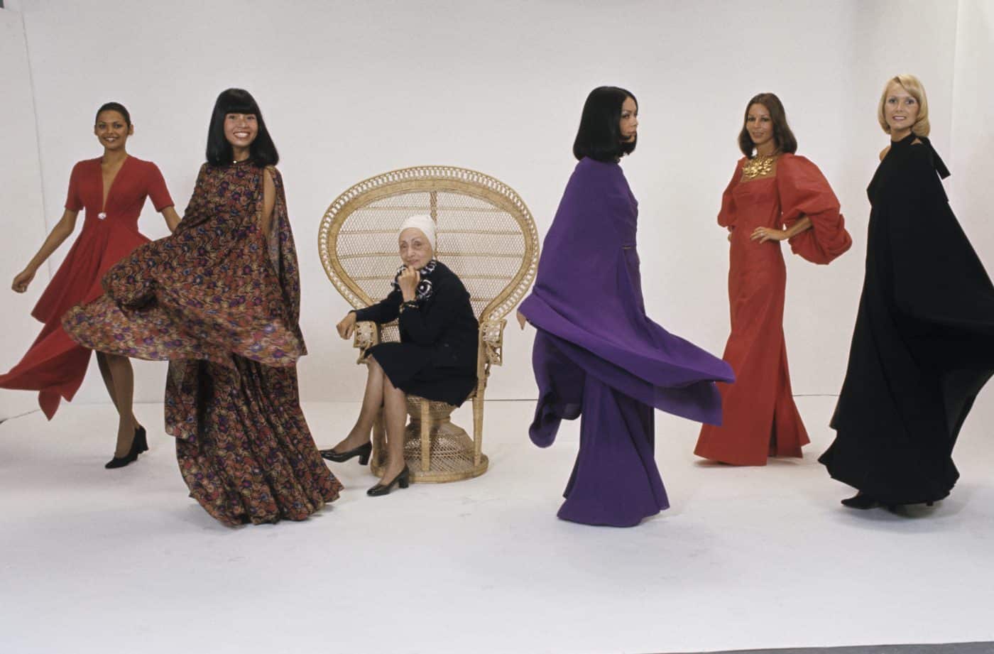 Foto von Madame Grès in ihrer Pariser Boutique zwischen Models, die ihre Entwürfe tragen